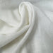 Natural lightweight sheer fabric with a refined texture, ideal for curtains and drapery. High-quality and stylish for any space.