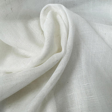 Natural lightweight sheer fabric with a refined texture, ideal for curtains and drapery. High-quality and stylish for any space.